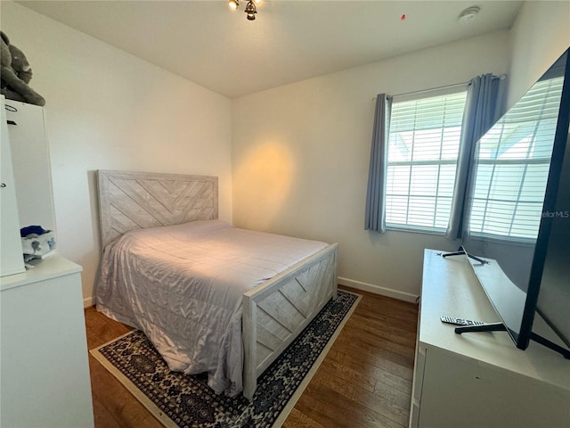 bedroom featuring baseboards and wood finished floors