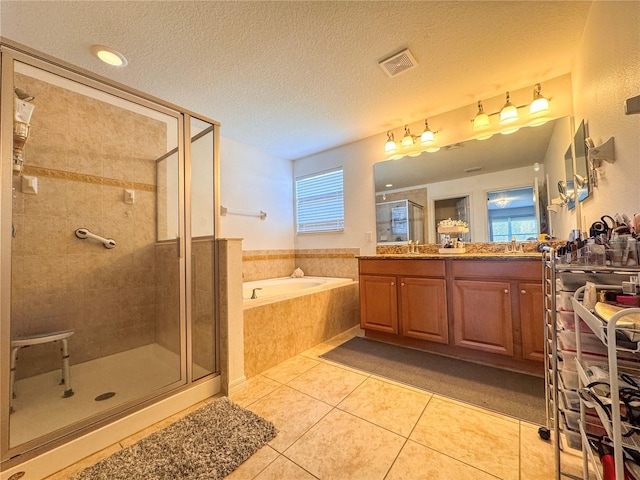 bathroom featuring a garden tub, visible vents, a stall shower, vanity, and tile patterned flooring