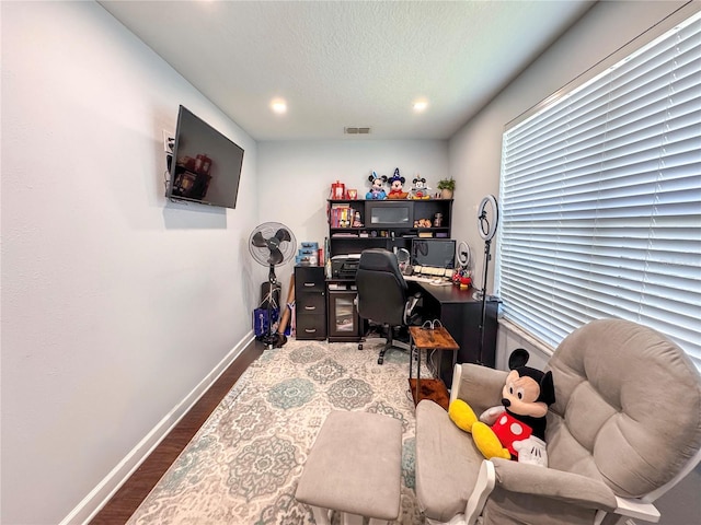 office space featuring recessed lighting, visible vents, a textured ceiling, wood finished floors, and baseboards