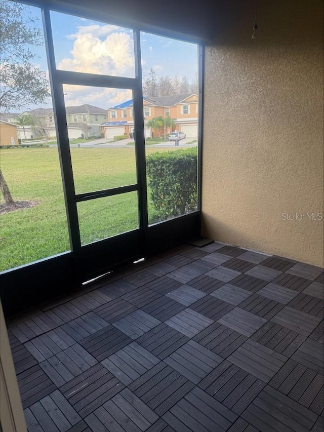 unfurnished sunroom featuring a residential view