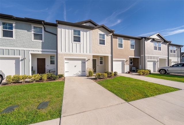 multi unit property featuring driveway, a front lawn, board and batten siding, and an attached garage