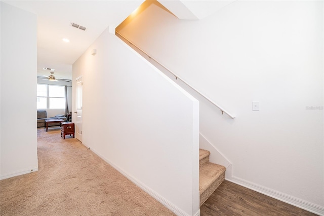 staircase with baseboards, visible vents, and carpet flooring