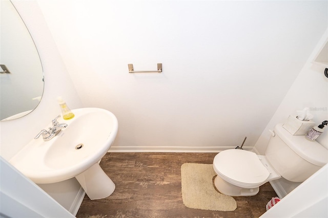 bathroom featuring baseboards, toilet, and wood finished floors