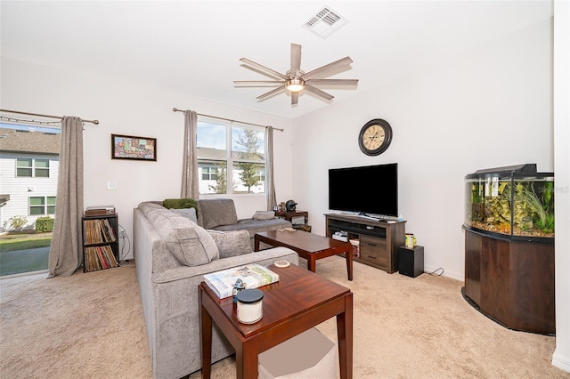 living room with vaulted ceiling, visible vents, ceiling fan, and light carpet