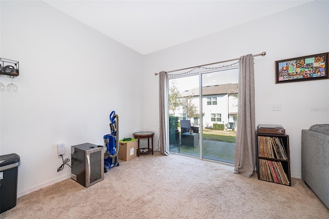 miscellaneous room with vaulted ceiling, carpet floors, and baseboards