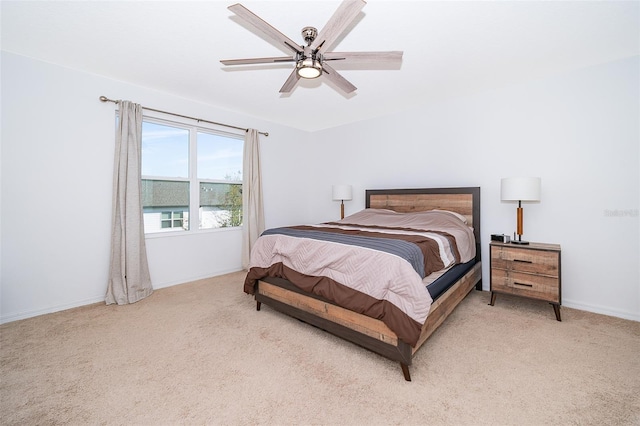 bedroom with light carpet, a ceiling fan, and baseboards