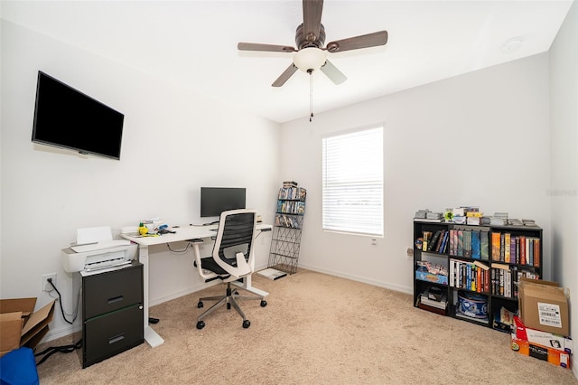 office featuring carpet floors, ceiling fan, and baseboards