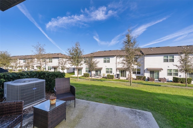 view of community featuring a yard, a patio area, and a residential view