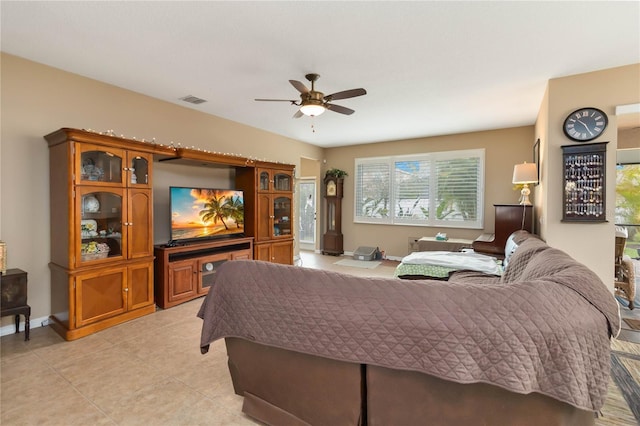 bedroom with visible vents, ceiling fan, baseboards, and light tile patterned floors