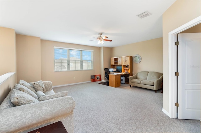 living room featuring light colored carpet, visible vents, ceiling fan, and baseboards