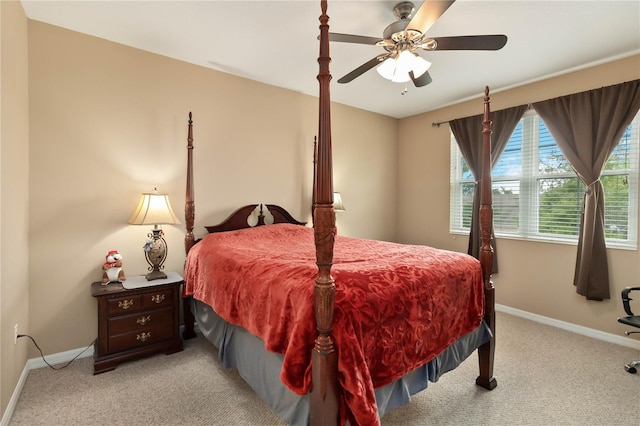 bedroom featuring light carpet, ceiling fan, and baseboards