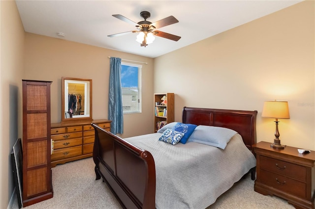 bedroom with ceiling fan and light colored carpet