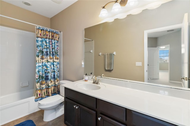 bathroom with toilet, tile patterned flooring, shower / tub combo with curtain, and vanity