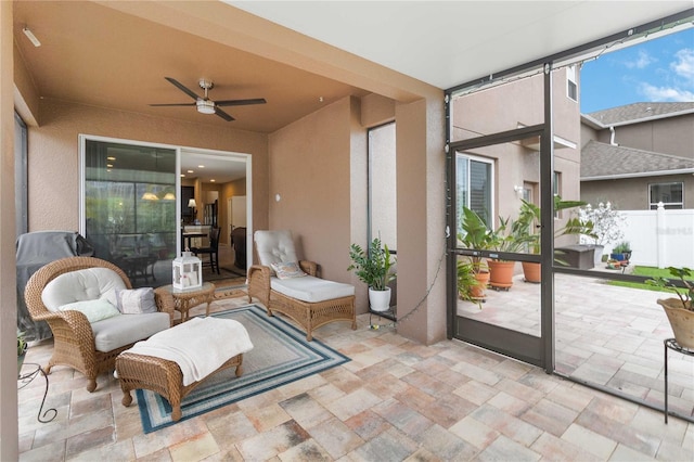 view of patio featuring ceiling fan and fence