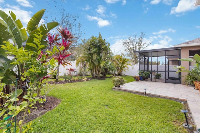 view of yard with a sunroom, a fenced backyard, and a patio