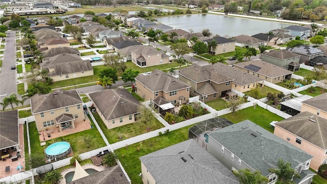 drone / aerial view featuring a water view and a residential view