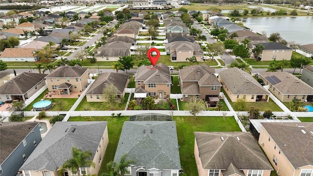 birds eye view of property featuring a residential view and a water view