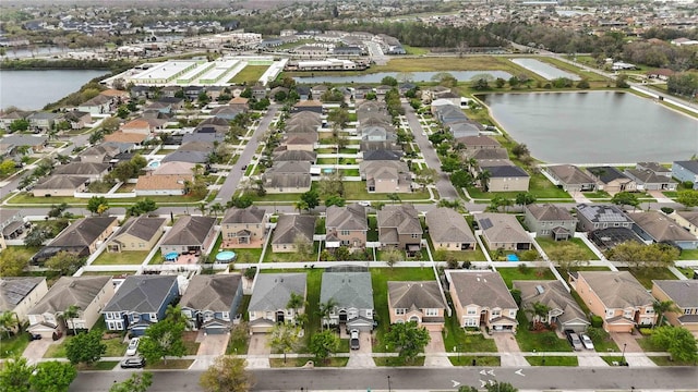 bird's eye view with a water view and a residential view