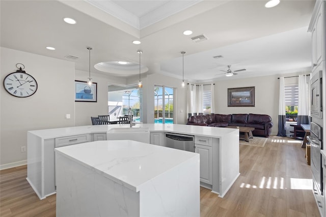 kitchen featuring recessed lighting, a kitchen island, visible vents, light wood-style floors, and appliances with stainless steel finishes