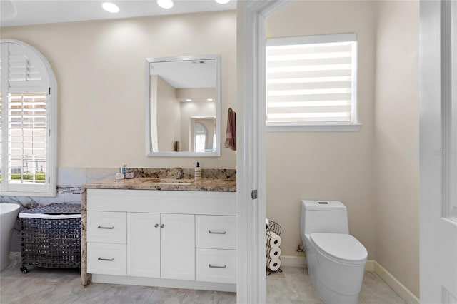 bathroom featuring toilet and vanity