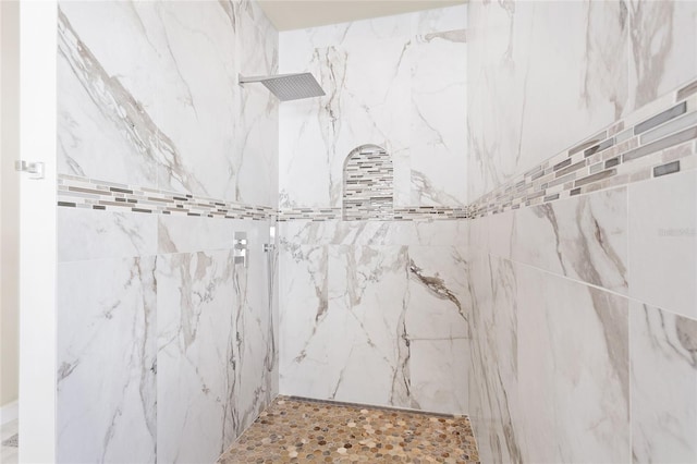 full bathroom featuring a marble finish shower