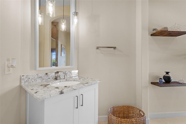 bathroom with tile patterned floors, baseboards, and vanity