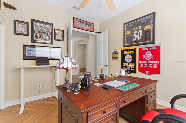 office featuring ceiling fan, visible vents, and baseboards