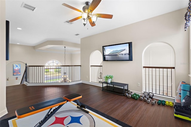 recreation room featuring visible vents, baseboards, and wood finished floors