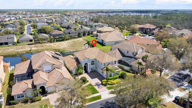 bird's eye view with a residential view and a water view