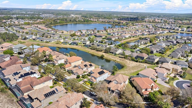 birds eye view of property featuring a water view and a residential view