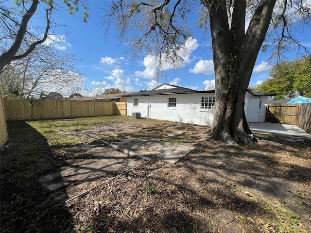 back of property featuring cooling unit, a patio area, a fenced backyard, and stucco siding