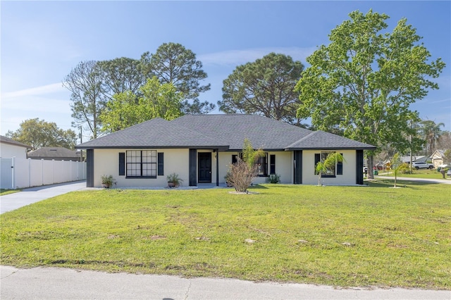 ranch-style home with a front yard, fence, and stucco siding