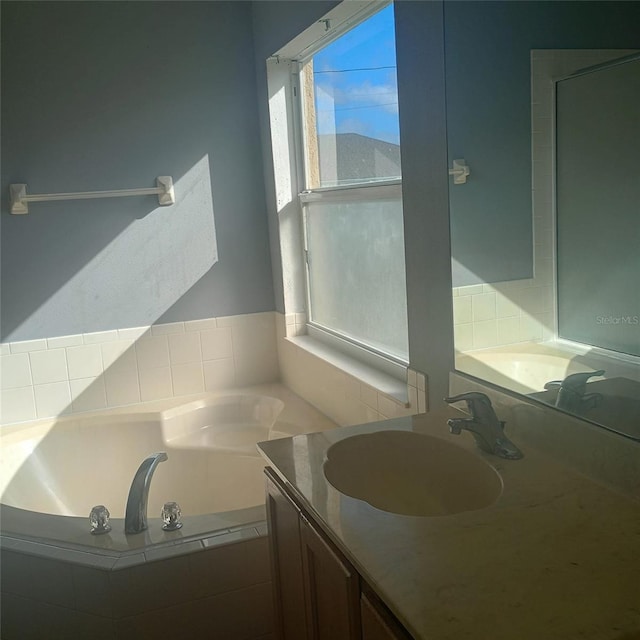 full bathroom featuring a bath and vanity