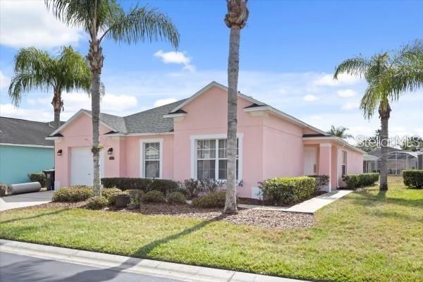 single story home featuring driveway, a front lawn, an attached garage, and stucco siding