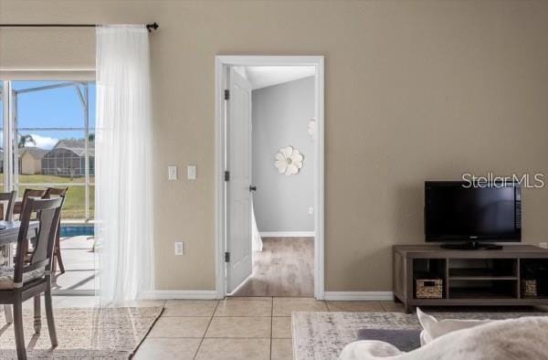 living room with tile patterned flooring and baseboards