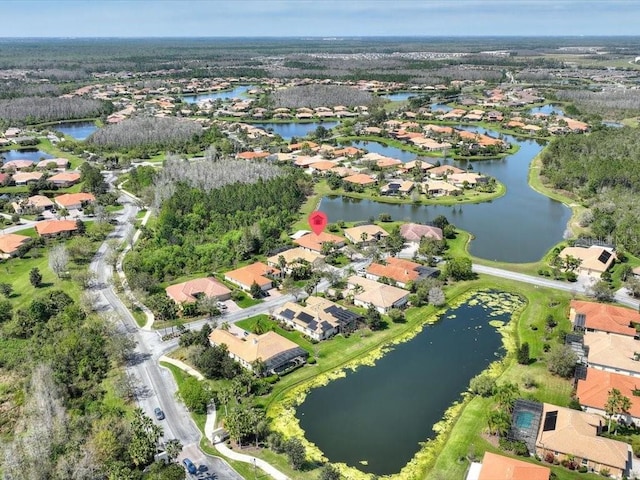 birds eye view of property featuring a residential view and a water view