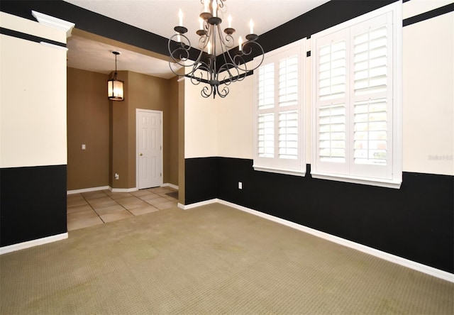 unfurnished room with tile patterned floors, a notable chandelier, baseboards, and carpet