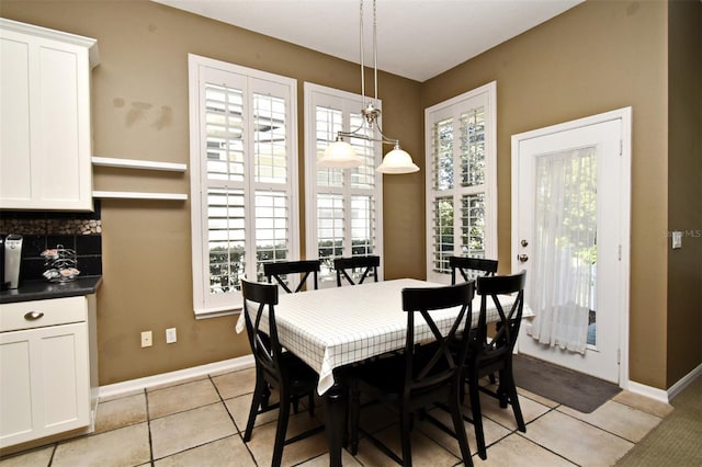 dining room with light tile patterned floors and baseboards