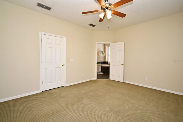 unfurnished bedroom with visible vents, baseboards, and carpet