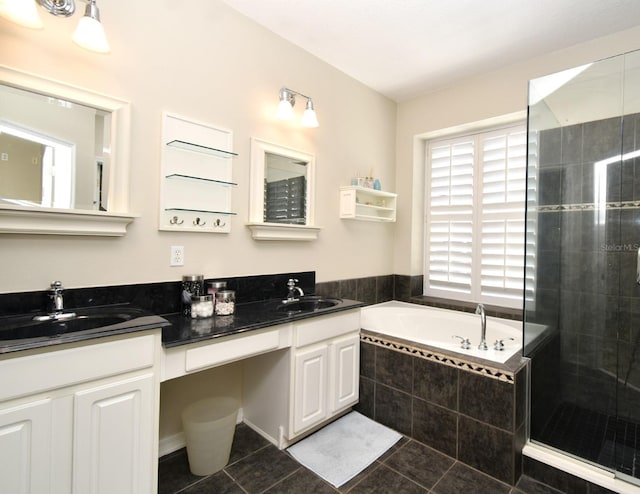 bathroom featuring a garden tub, a stall shower, a sink, tile patterned flooring, and double vanity