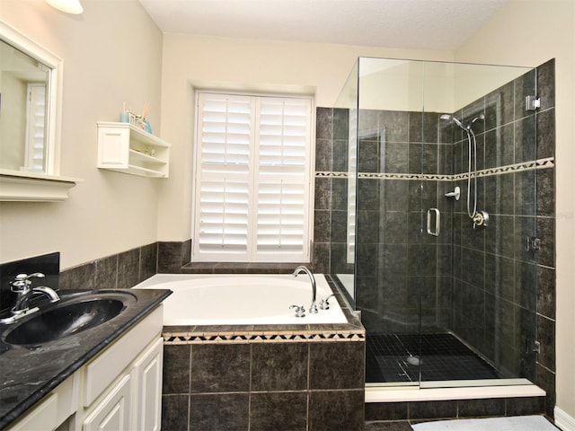 bathroom with vanity, a bath, and a stall shower