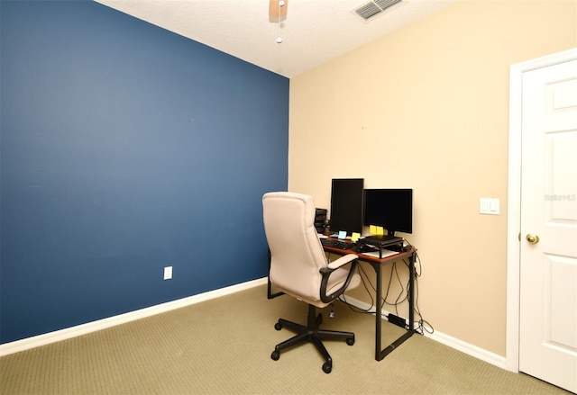 office area featuring visible vents, baseboards, carpet, and a ceiling fan