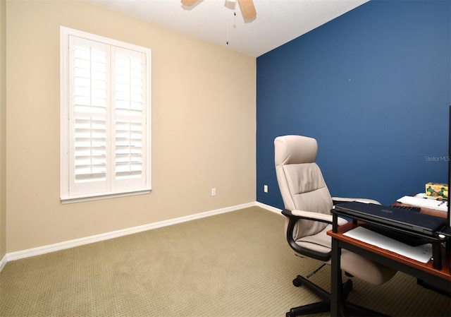 unfurnished office with carpet, baseboards, and ceiling fan