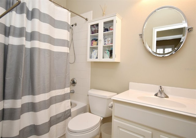 bathroom with vanity, shower / bath combination with curtain, and toilet