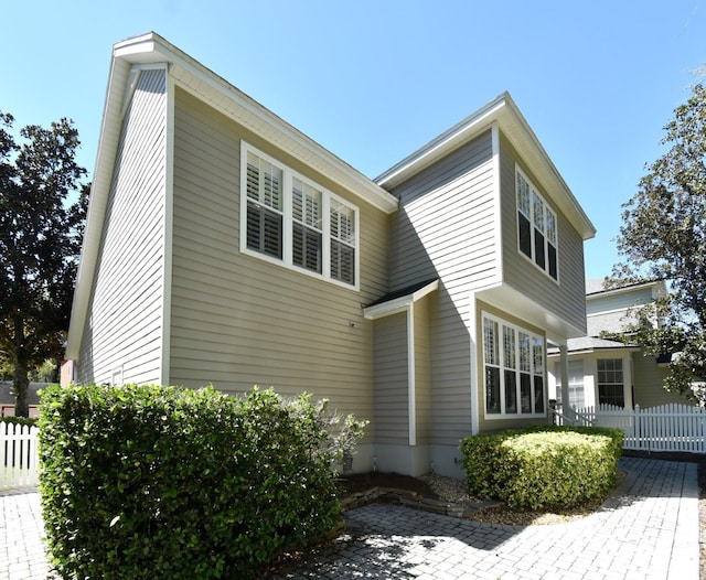 view of side of property featuring fence