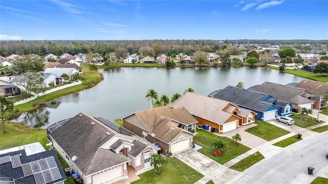 drone / aerial view featuring a water view and a residential view