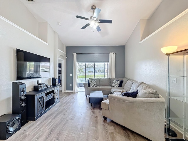 living area with baseboards, ceiling fan, and light wood finished floors