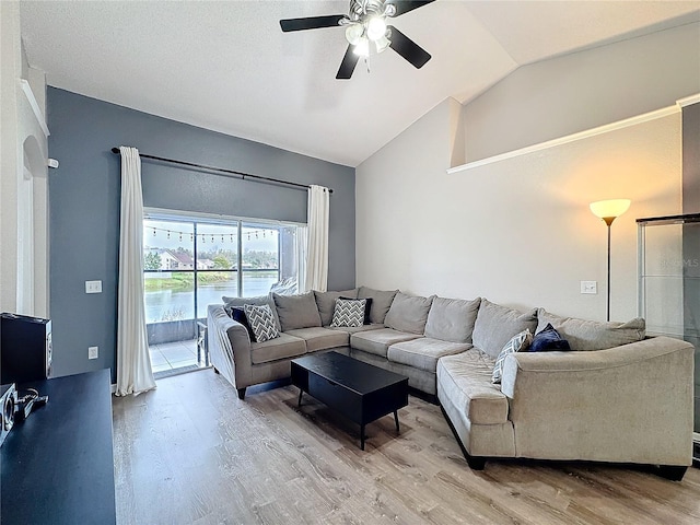 living room featuring lofted ceiling, ceiling fan, and wood finished floors