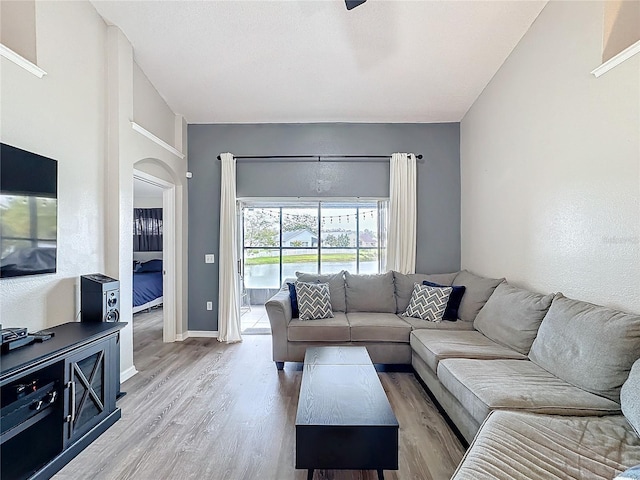 living area with baseboards and wood finished floors