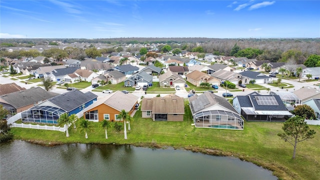 drone / aerial view featuring a water view and a residential view